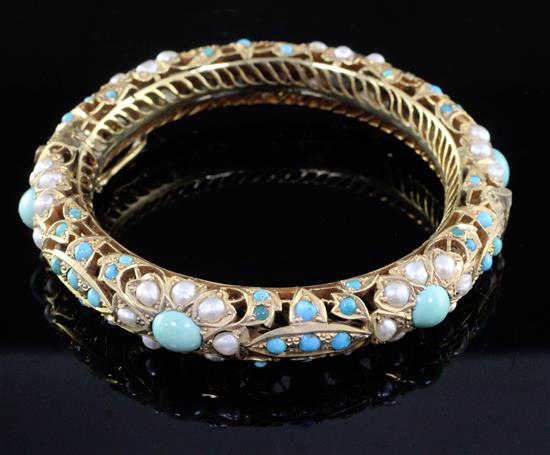 An Indian gilt metal split pearl and turquoise set hinged bangle.